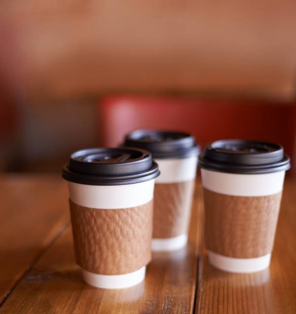 custom coffee cup sleeves, customers hands, custom printed coffee sleeves, trade shows